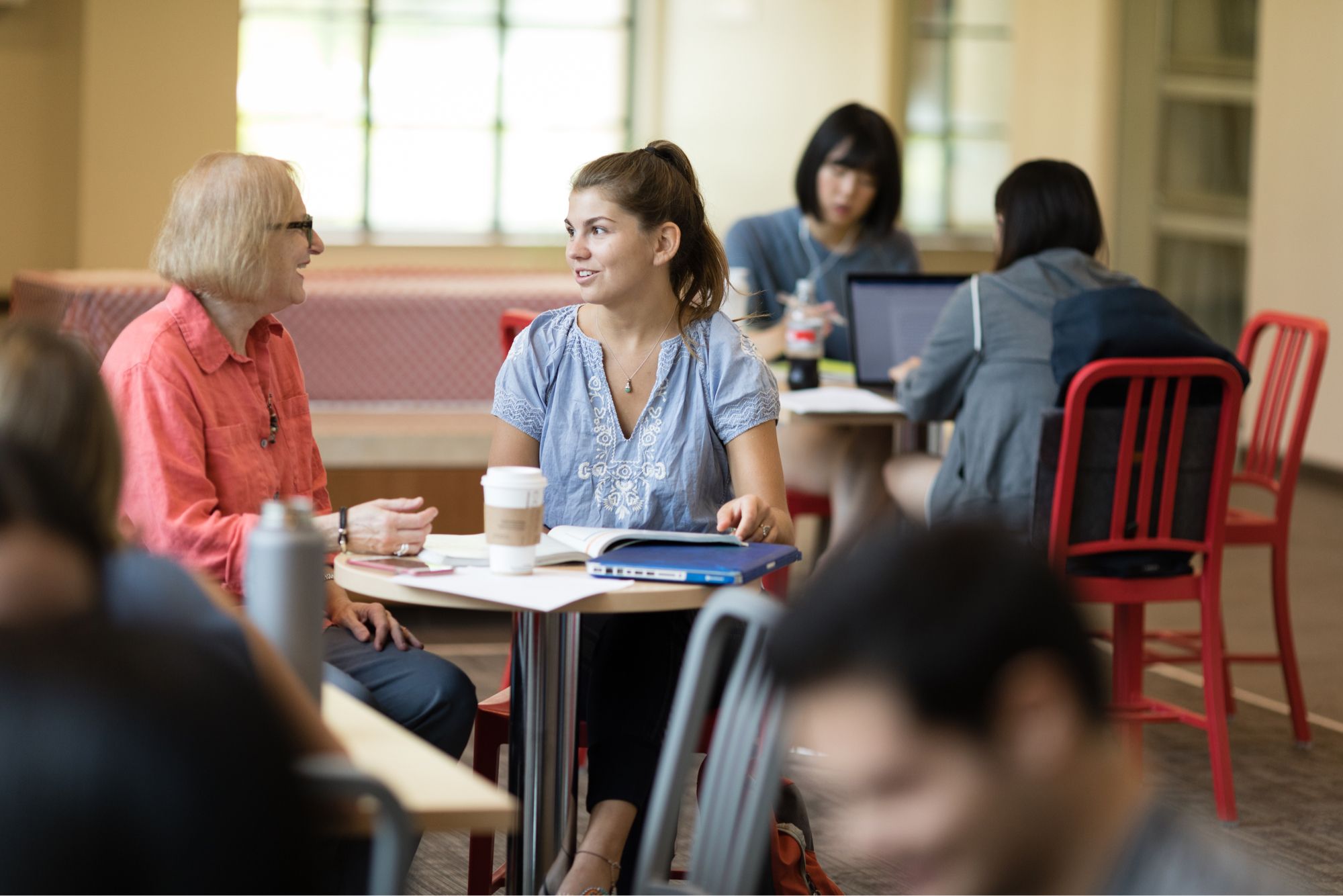 Latin American & Caribbean studies student and professor meet for coffee to discuss a project.