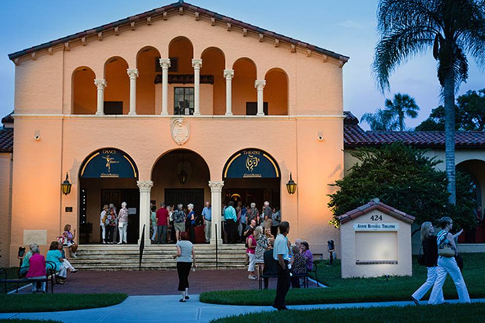 The exterior of the Annie Russell Theatre with people bustling about