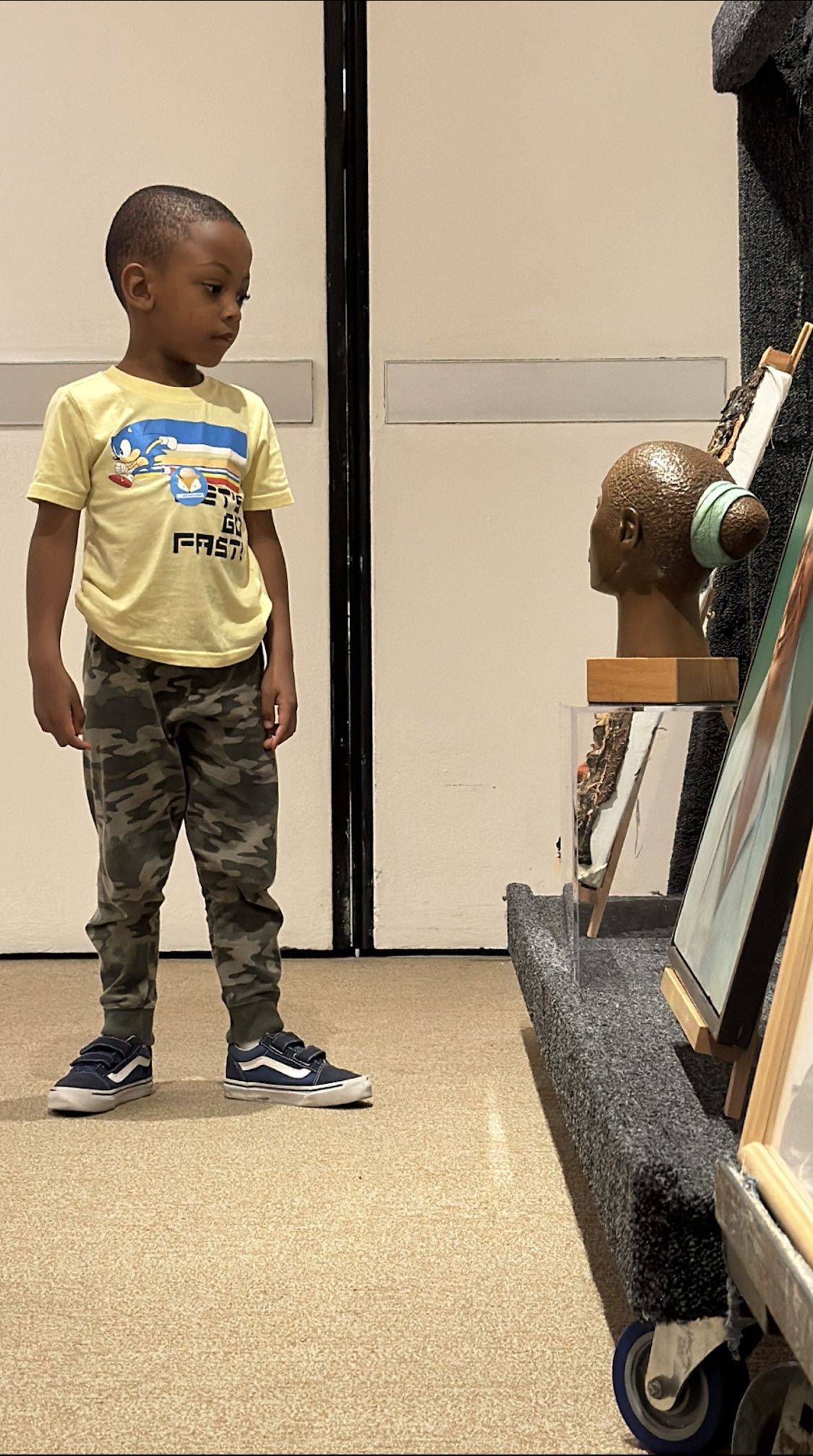 A five-year-old child chooses his favorite artwork among a selection of works from the RMA collection. Photo courtesy of the Hume House Child Development & Student Research Center