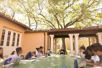 Rollins professor Dan Chong leads a discussion with students in the Orlando Hall outdoor classroom.