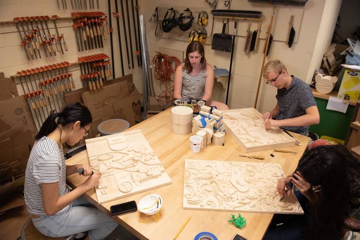 Students use chisels to clean up their milled projects.