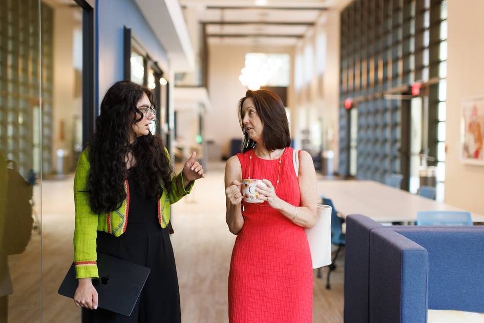 A Rollins student walks with a professor.