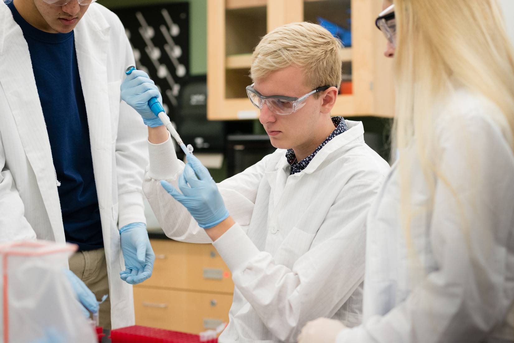 Issac Gorres ’21 working with fellow students in a biology lab.