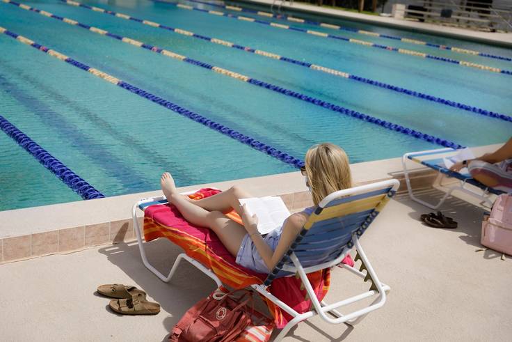 Student studying at the Alfond Swimming Pool.