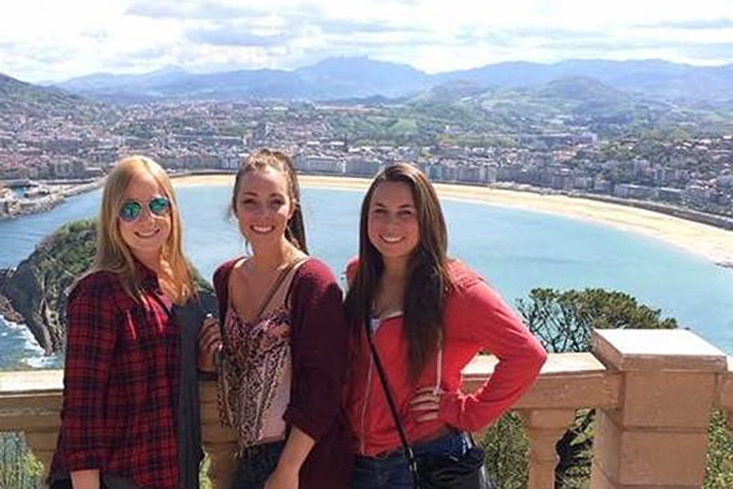 Students smiling to camera at a lookout over Oviedo, Spain.