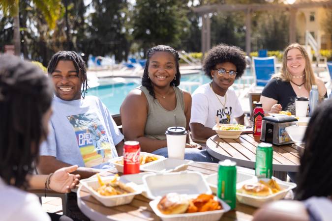 Students interacting at a campus patio.