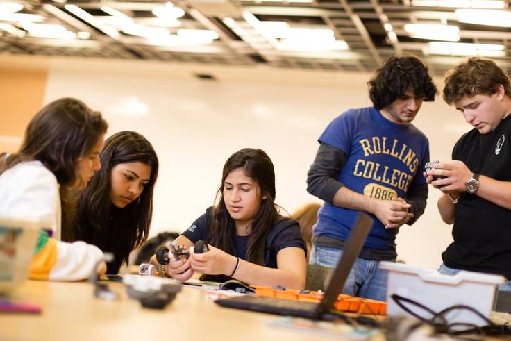 A group of college students build robots.