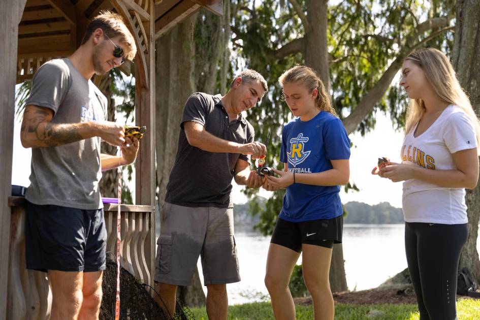 Biology professor Bobby Fokidis and his students examine turtles from Lake Virginia