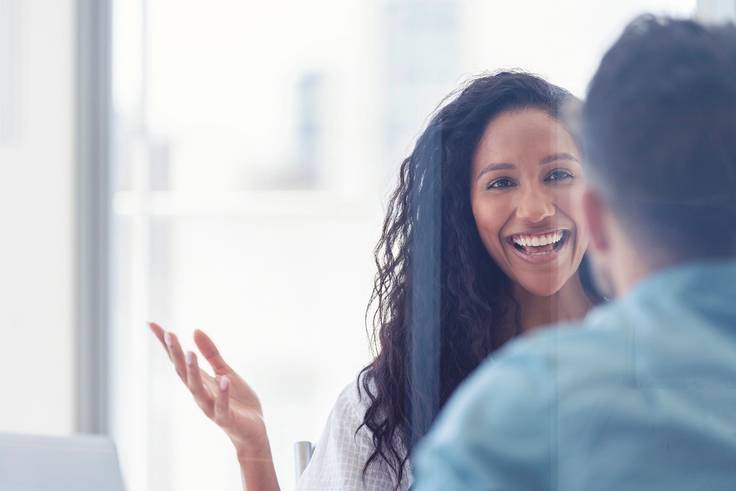 A human resources professional discusses benefits with a new hire.