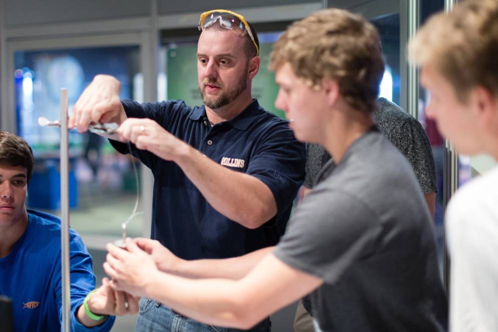 Dr Fuse assists students with a lab in a course about the science of superheroes.