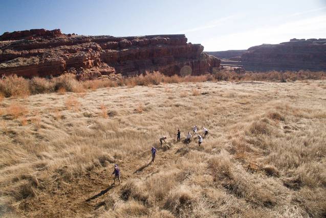 A group of liberal arts college students looking out into a valley during the sunset in Moab, Utah.
