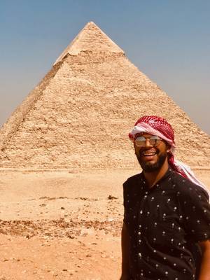 Raul Tavarez Ramirez ’21 pictured with a pyramid in Jordan on a study abroad experience.