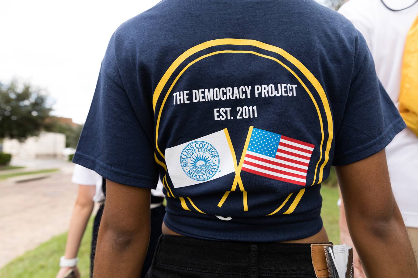 A student sports a Democracy Project T-shirt on campus.