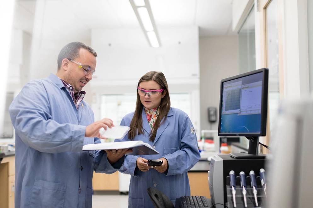 Ames and her professor Patrone together in the biology lab.