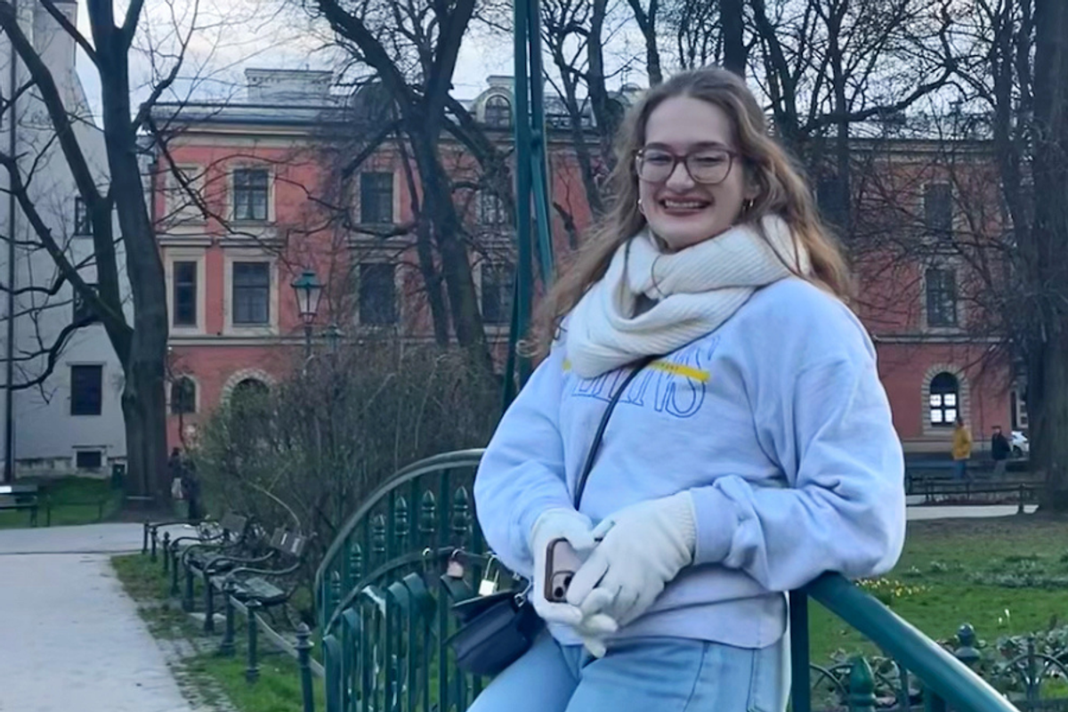 Rollins student, Angelina Davidson '25 poses on a bridge