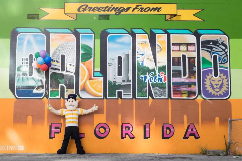 Rollins mascot Tommy Tar, poses in front an Orlando mural.
