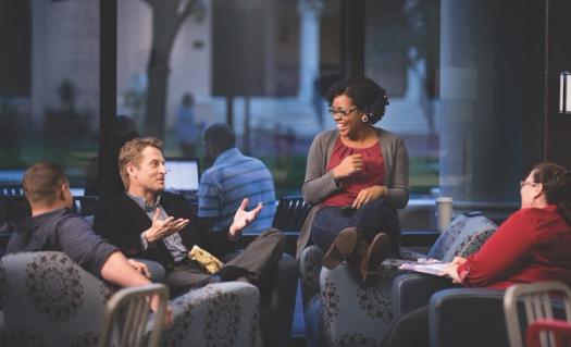 A group of Rollins students laugh and talk. 