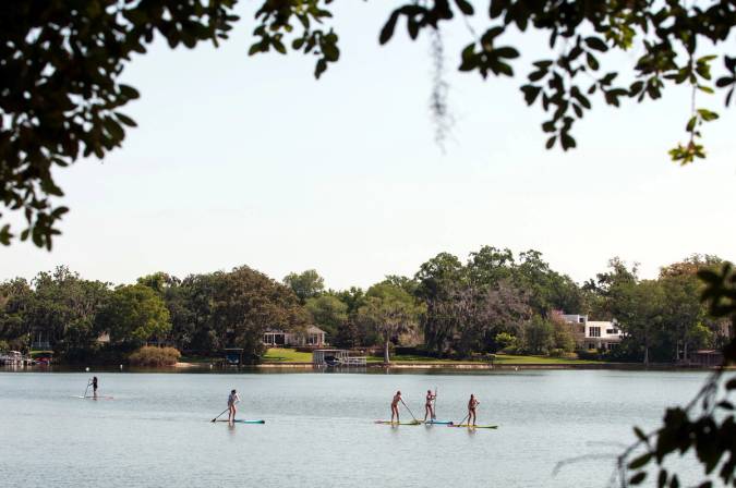 Students paddle board on Lake Virginia during Fox Day.