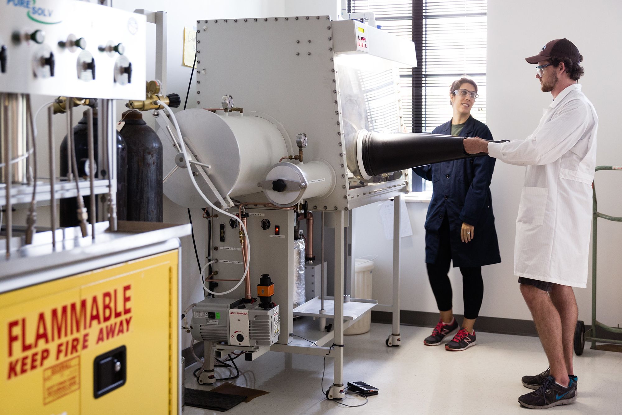 A professor and a student conduct chemistry research.