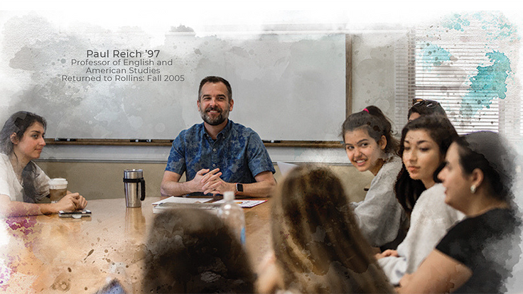 English professor Paul Reich in the classroom with students around an oval table.