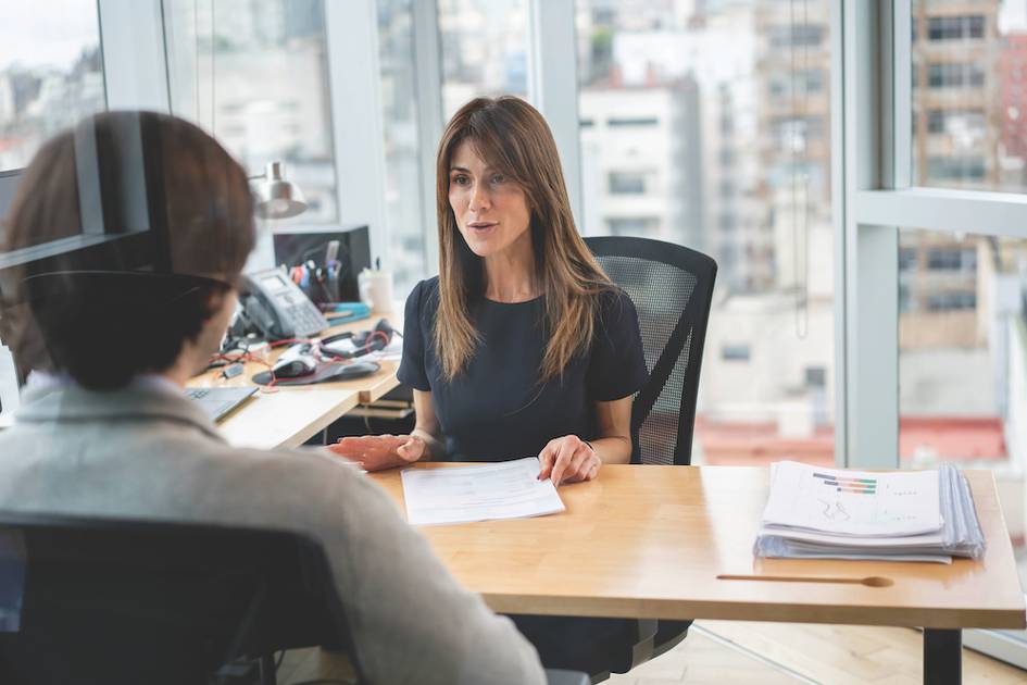 A business person meeting with a coworker in their office