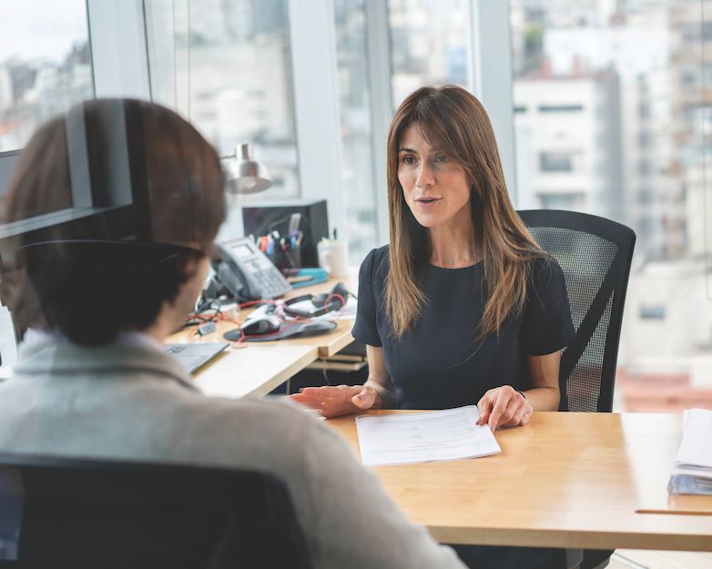 A human resources professional chats with a staff member.