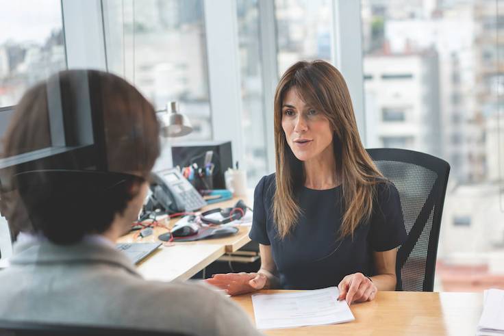 A human resources professional chats with a staff member.