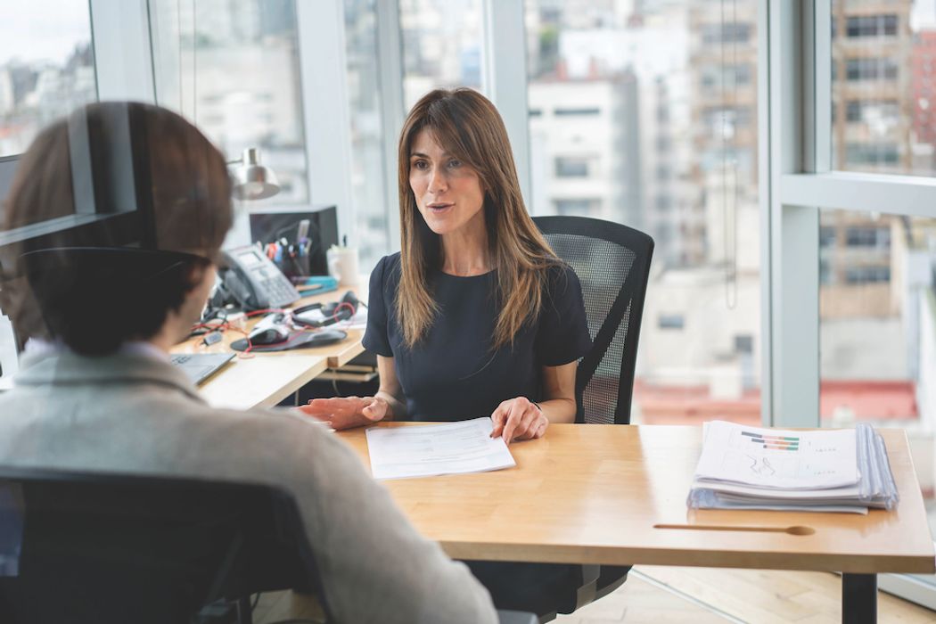 A business person meeting with a coworker in their office