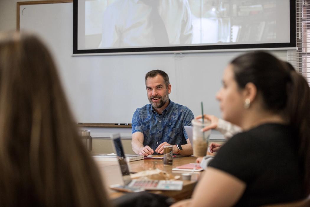 Rollins students have a discussion while in class. 