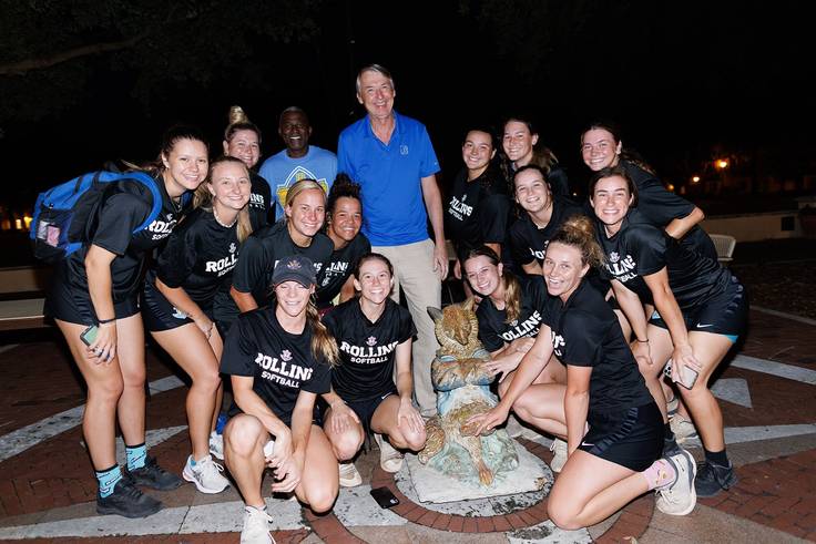 President Grant Cornwell and the softball team with the Fox statue. 