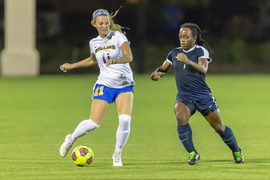 A women's soccer player sizes up a pass.