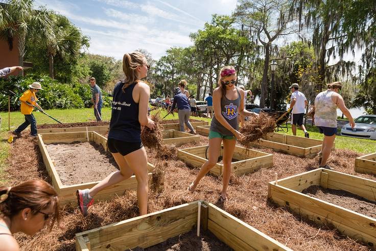 Rollins students tending the garden outside Elizabeth hall.