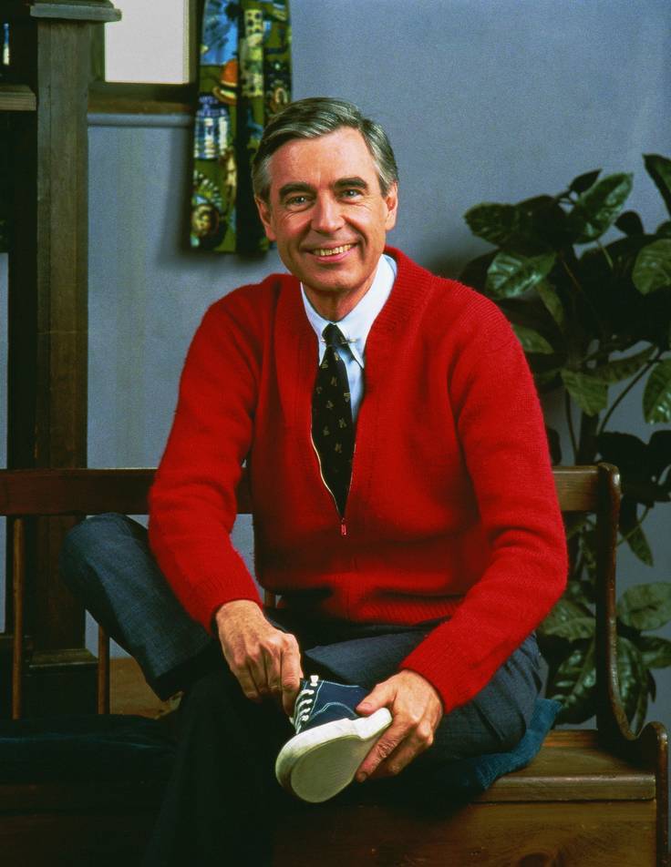 Mister Rogers putting on his famous blue sneakers on the set of Mister Rogers’ Neighborhood.