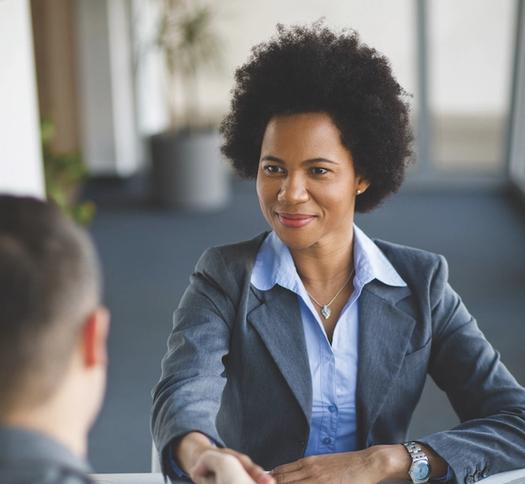 A professional shaking hands with in an interview