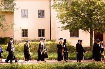 Rollins students walking toward their commencement ceremony.