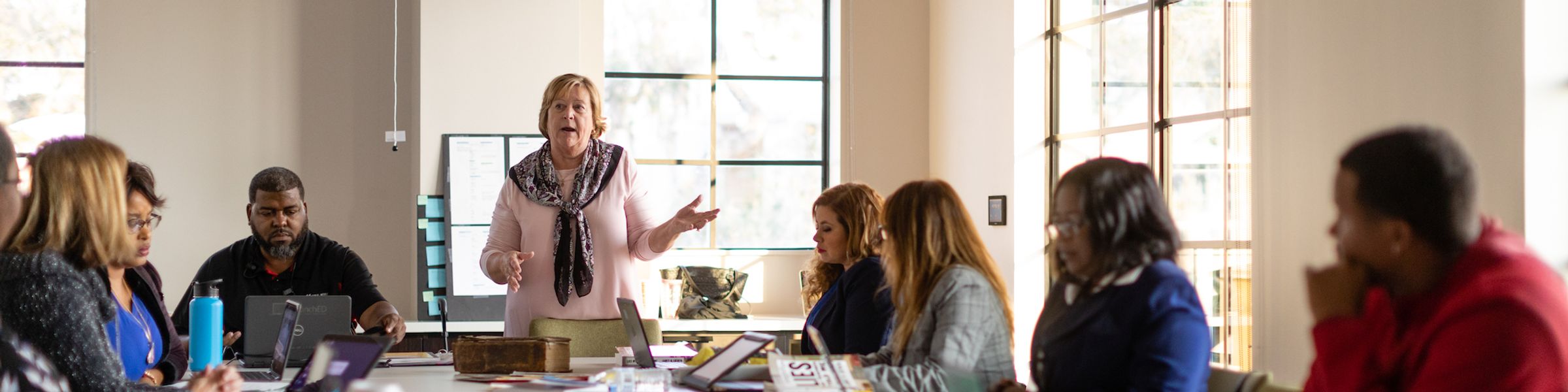 A education professor explains a concept to a small group of students.