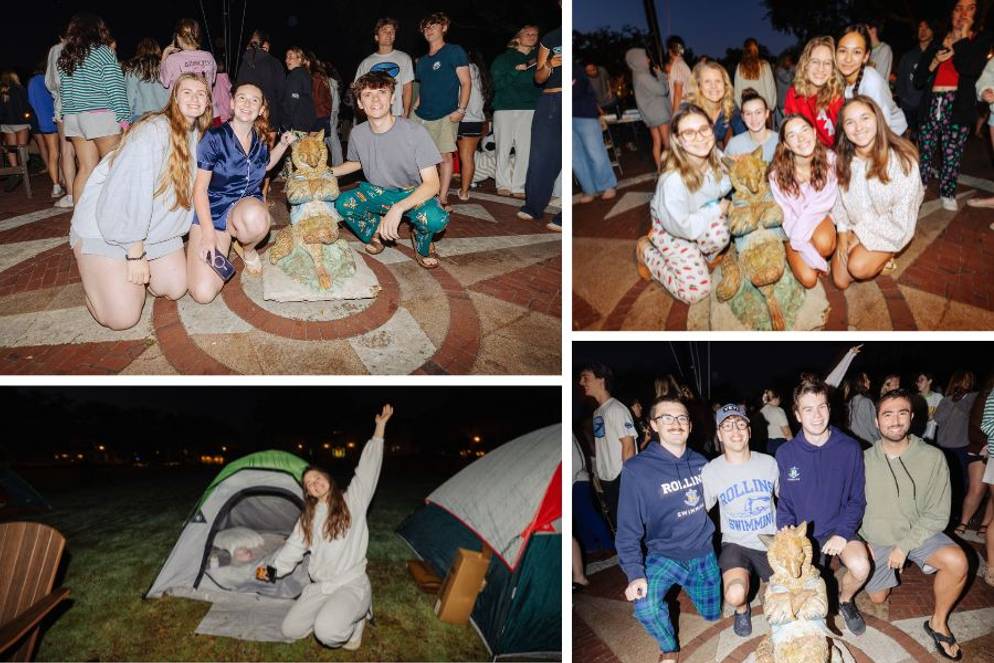 Students posing with the Fox statue and smiling in front of their tents