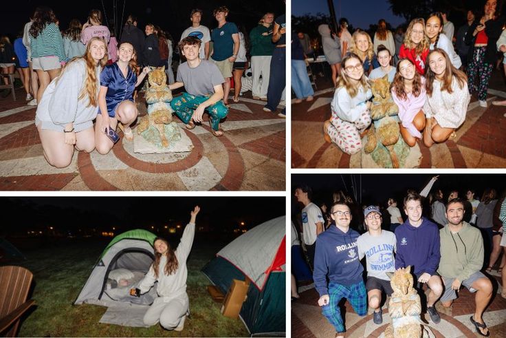 Students posing with the Fox statue and smiling in front of their tents