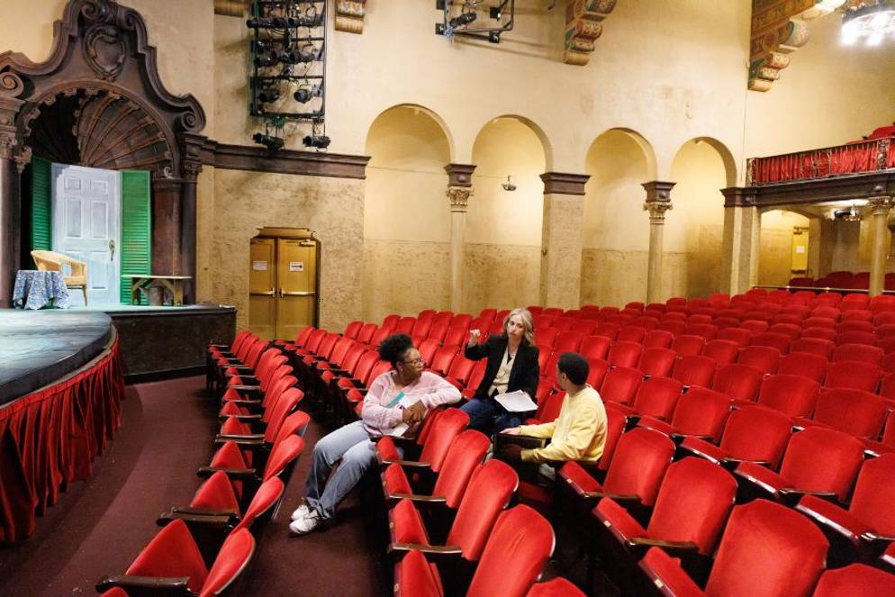 Professor DiQuattro talking with Yasmine Hudson ’27 and Max Payton ’27 inside the Annie Russell Theatre