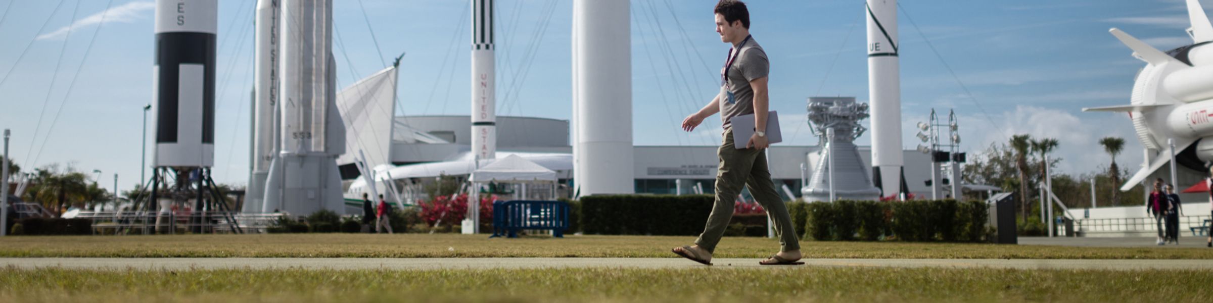 A Rollins student walks in the Rocket Garden at Kennedy Space Center.