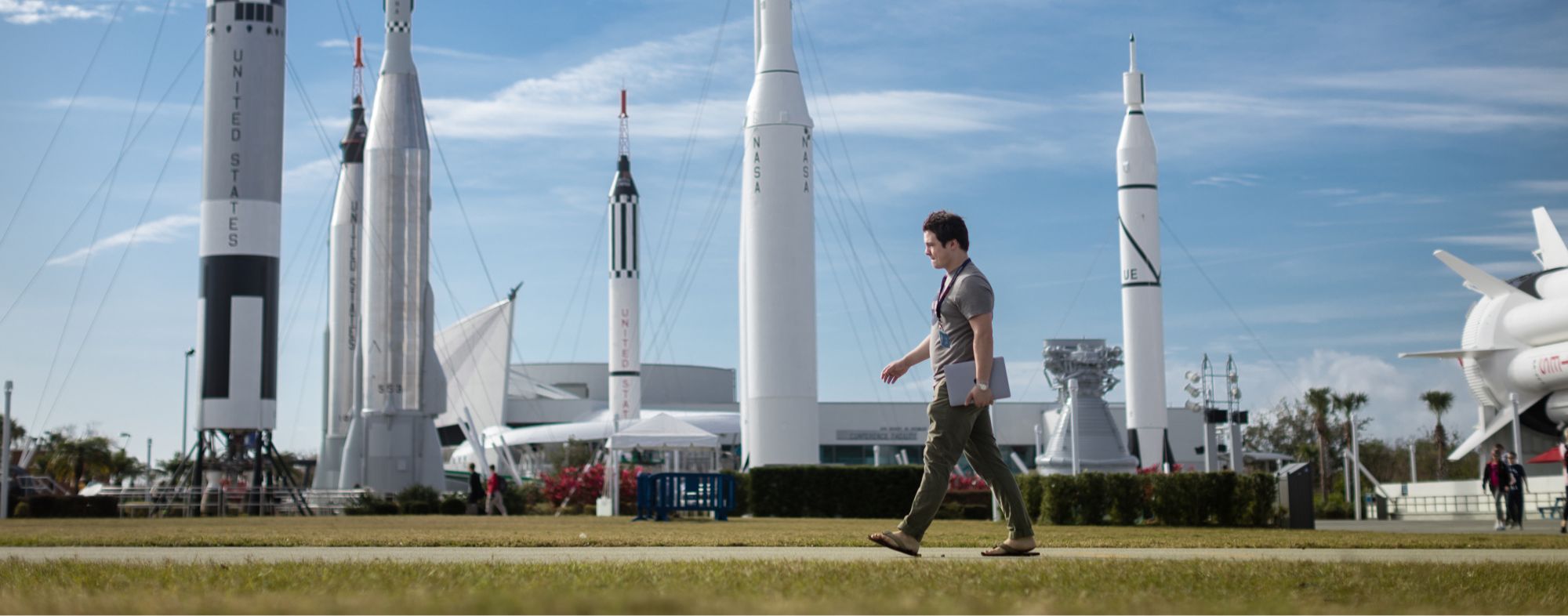 A Rollins student walks in the Rocket Garden at Kennedy Space Center.