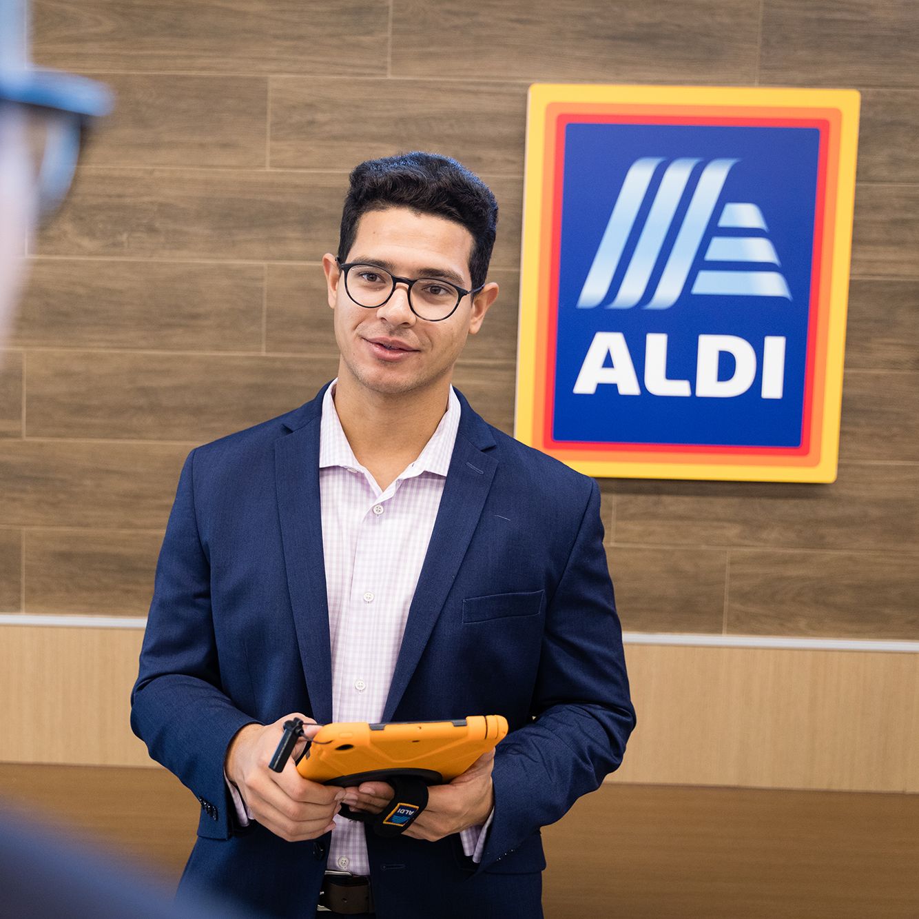 A student talks with his manager during an ALDI internship.