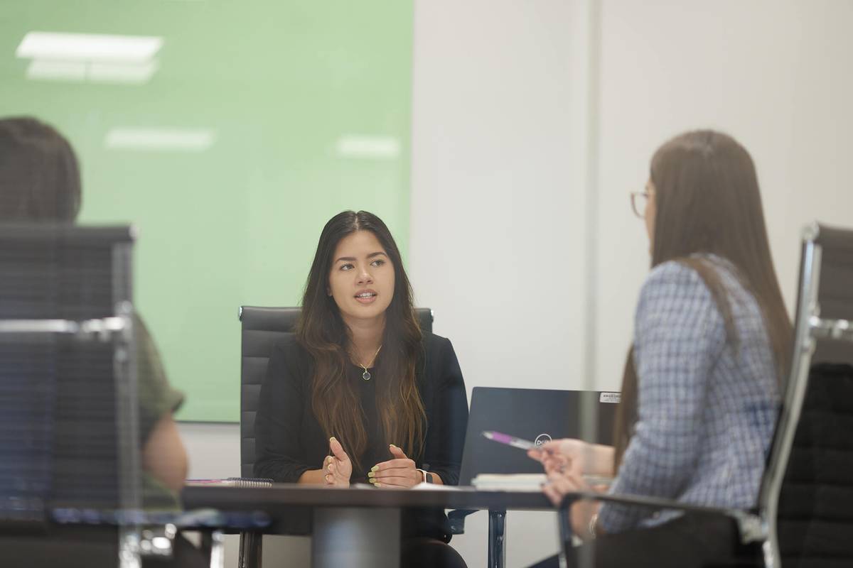Rollins grad Sonia Canizalez leads a meeting at StoneX.