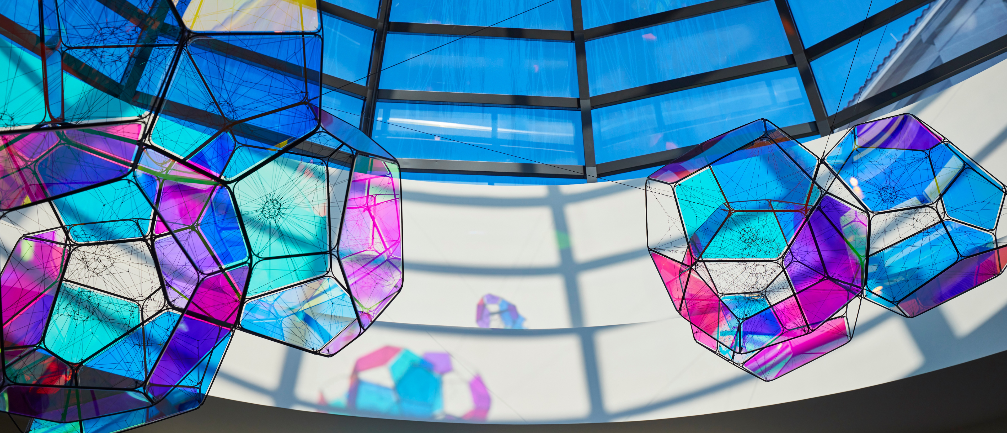 Colorful geometric glass panels with intersecting lines creating abstract pattern