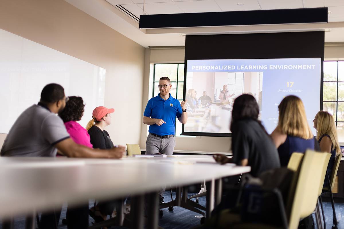 An admission counselor leads an information session.