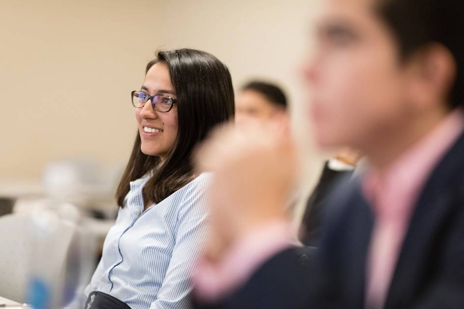 Smiling student listens during a classroom session.