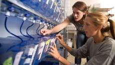 Marine biology students evaluating specimens in water tanks