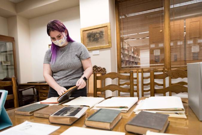 Masked student conducts research