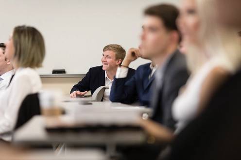 A student smiles during a business class at Rollins.