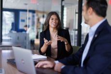 A business student meets one-on-one with a faculty advisor.